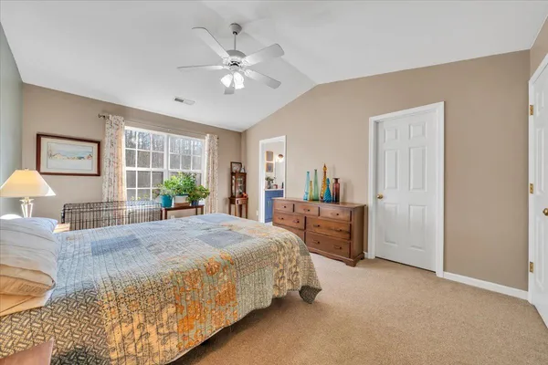 a bedroom with furniture and a window