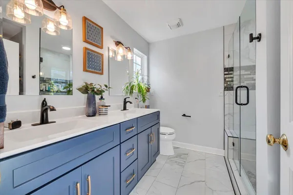 a bathroom with a sink mirror vanity and toilet