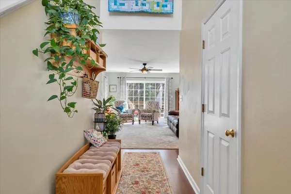 a living room with furniture a fireplace and a large window