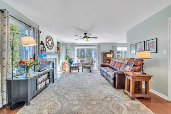 a living room with furniture a clock and a fireplace