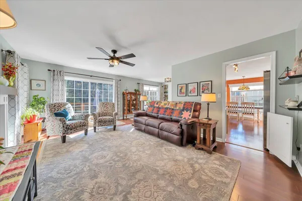 a living room with furniture and a wooden floor