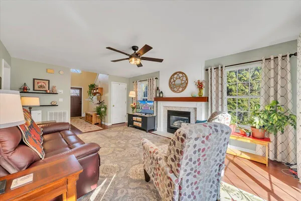 a kitchen with stainless steel appliances granite countertop a sink cabinets and wooden floor