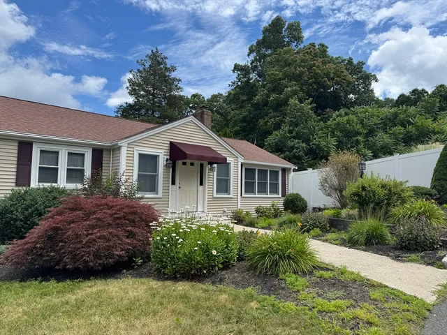 a front view of a house with a garden
