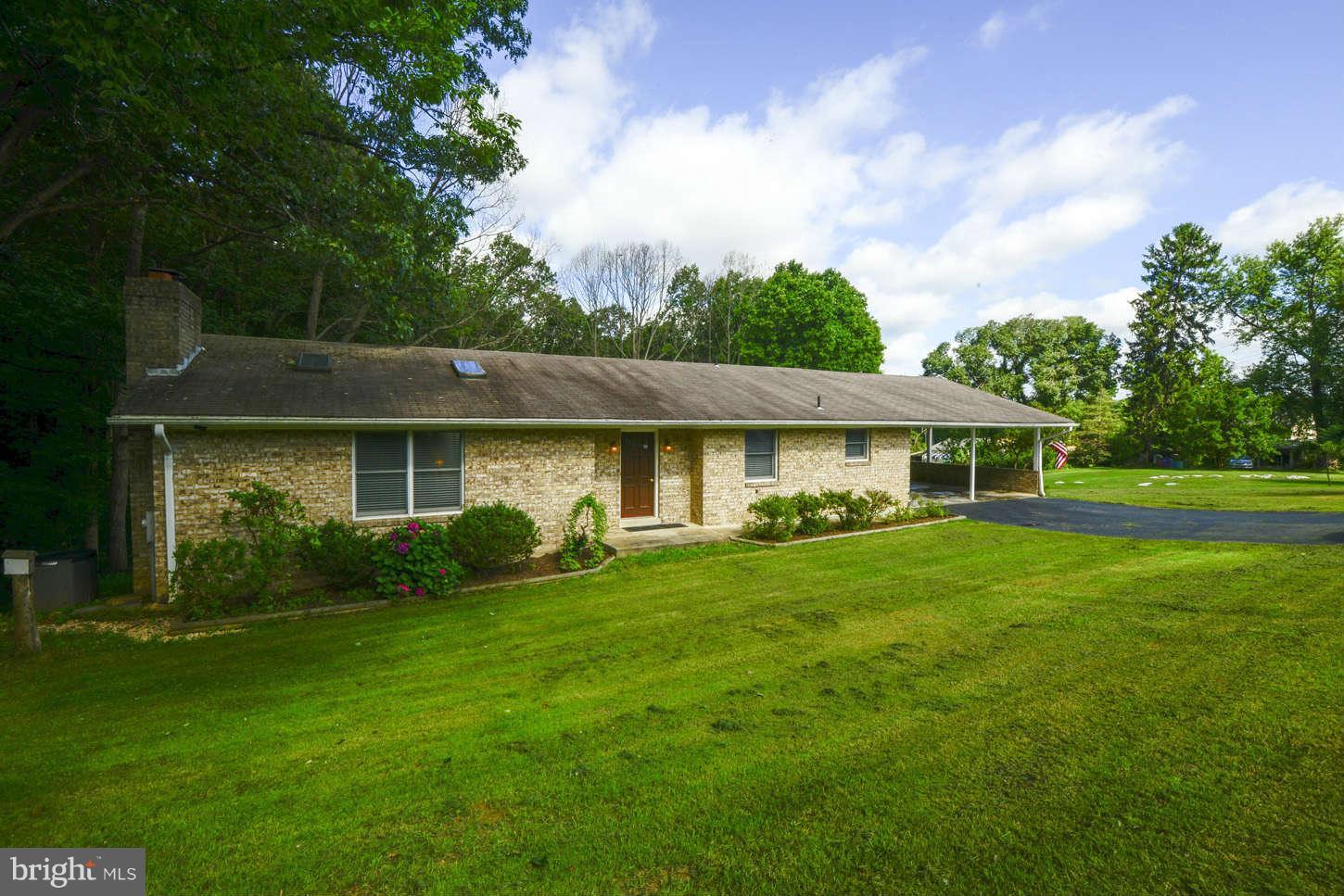 16590 Brogden Road Spencerville, MD 20868 - Photo 1 of 19 a front view of a house with garden