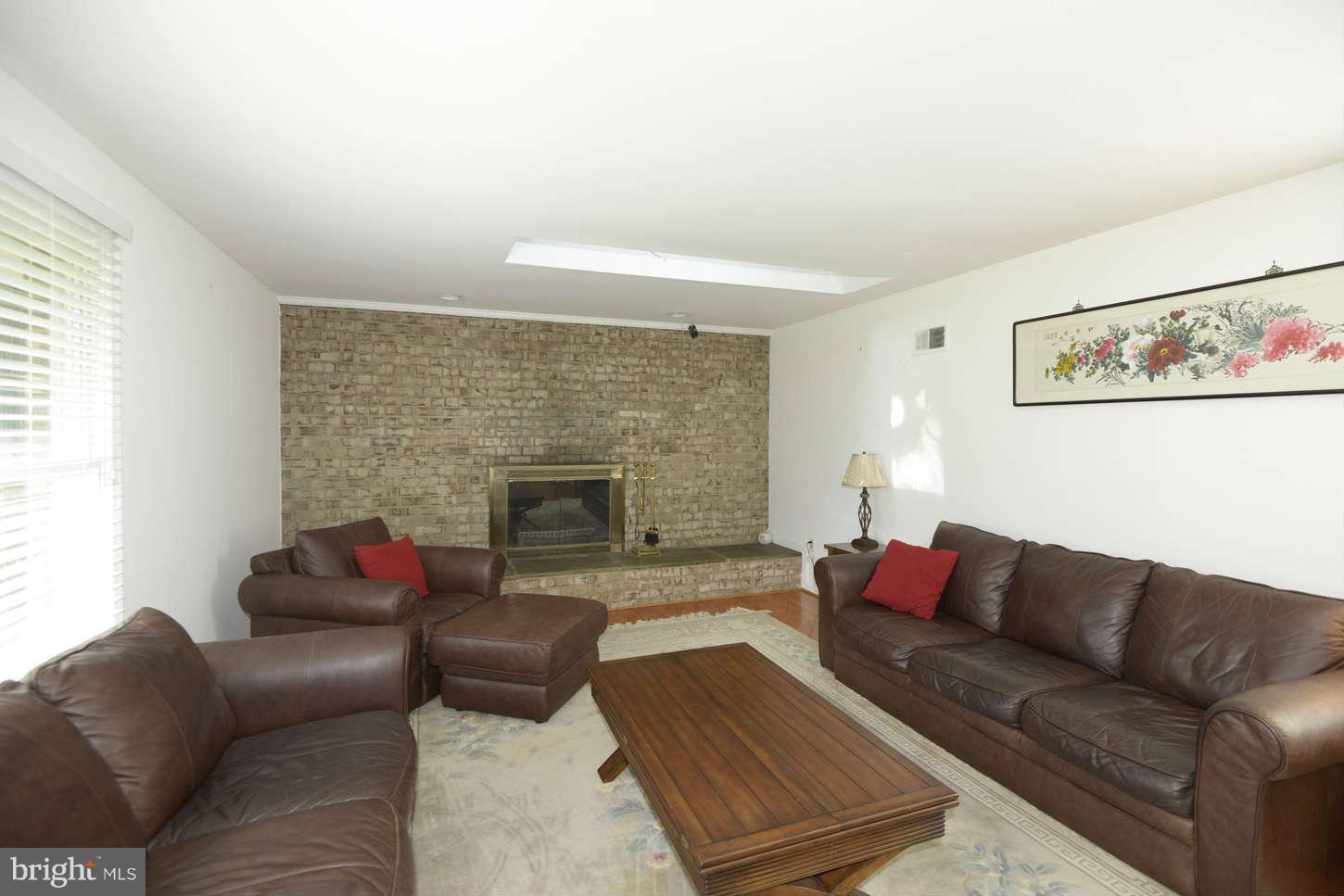 16590 Brogden Road Spencerville, MD 20868 - Photo 3 of 19 a living room with furniture and a fireplace