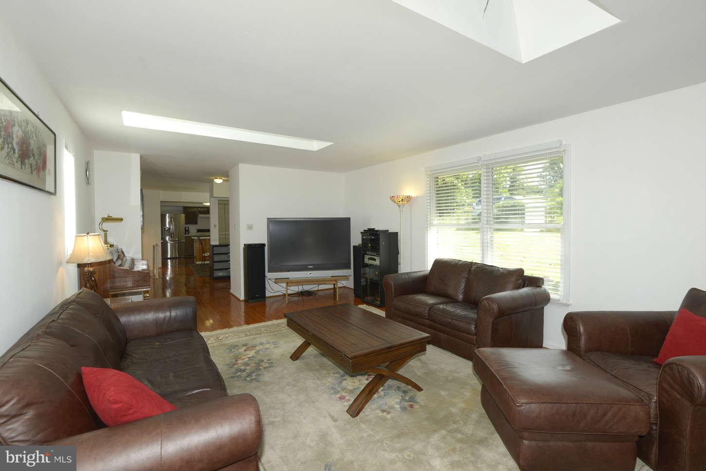 16590 Brogden Road Spencerville, MD 20868 - Photo 4 of 19 a living room with furniture and a flat screen tv