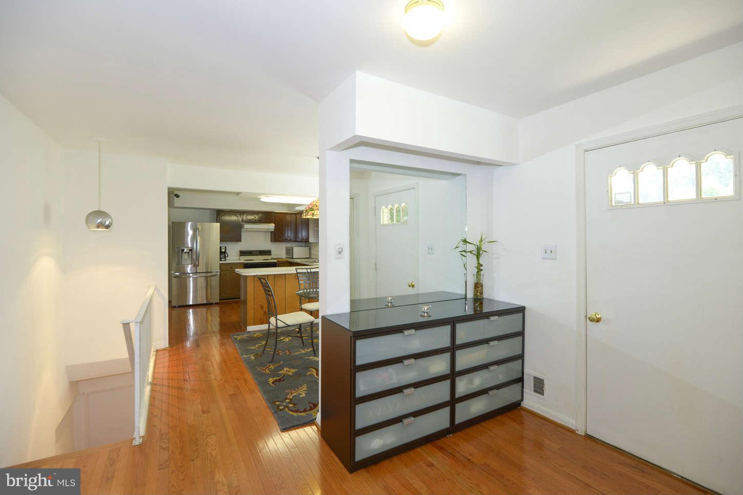 16590 Brogden Road Spencerville, MD 20868 - Photo 5 of 19 a room with a wooden floor and furniture