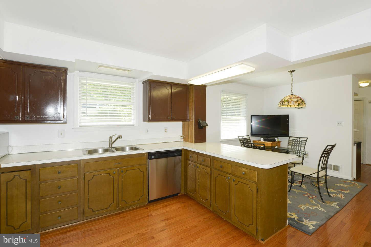 16590 Brogden Road Spencerville, MD 20868 - Photo 7 of 19 a kitchen with a sink a counter top space and appliances