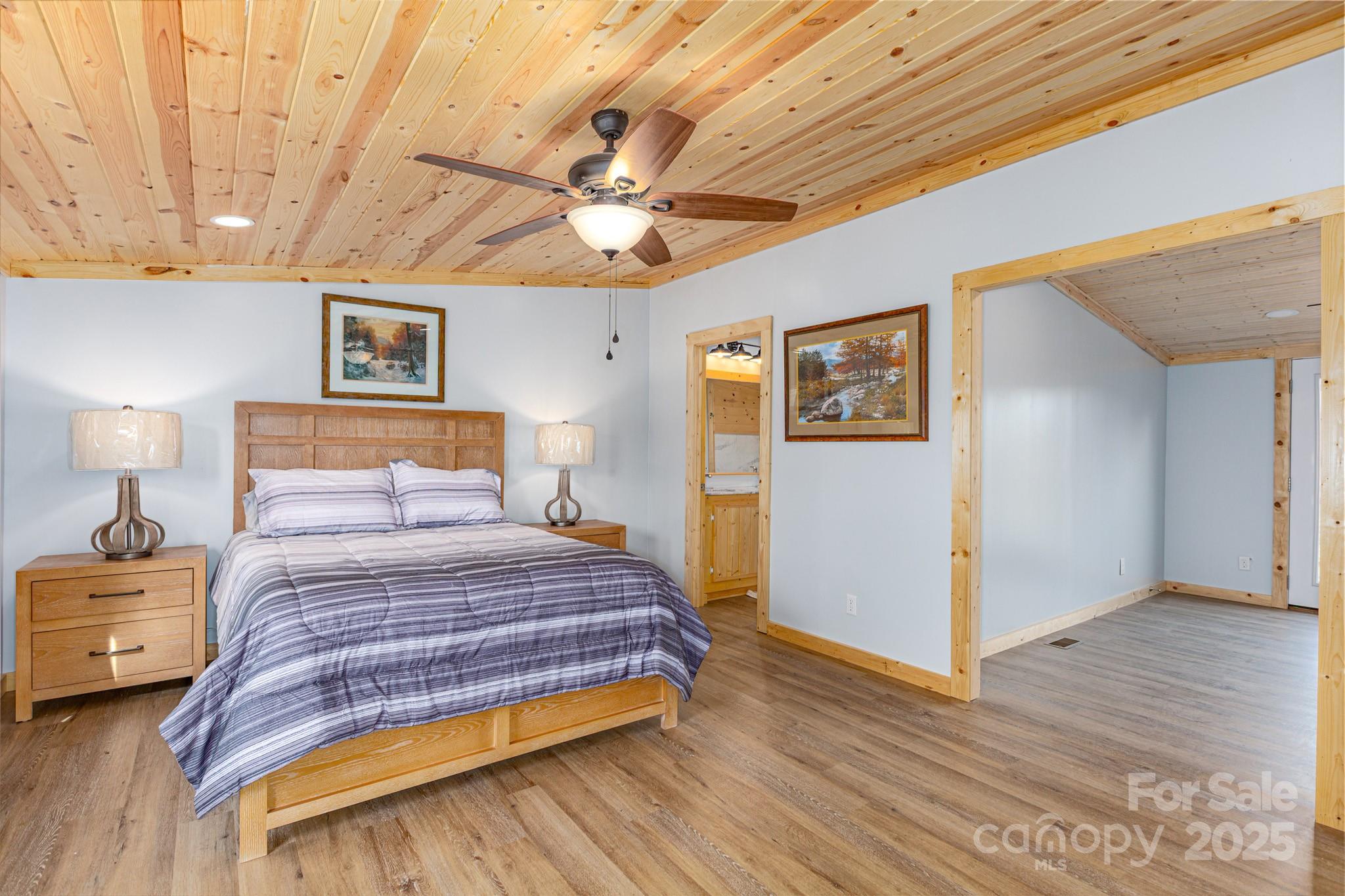 459 Vaughan Road Spruce Pine, NC 28777 - Photo 17 of 35 a bedroom with a bed and a chandelier