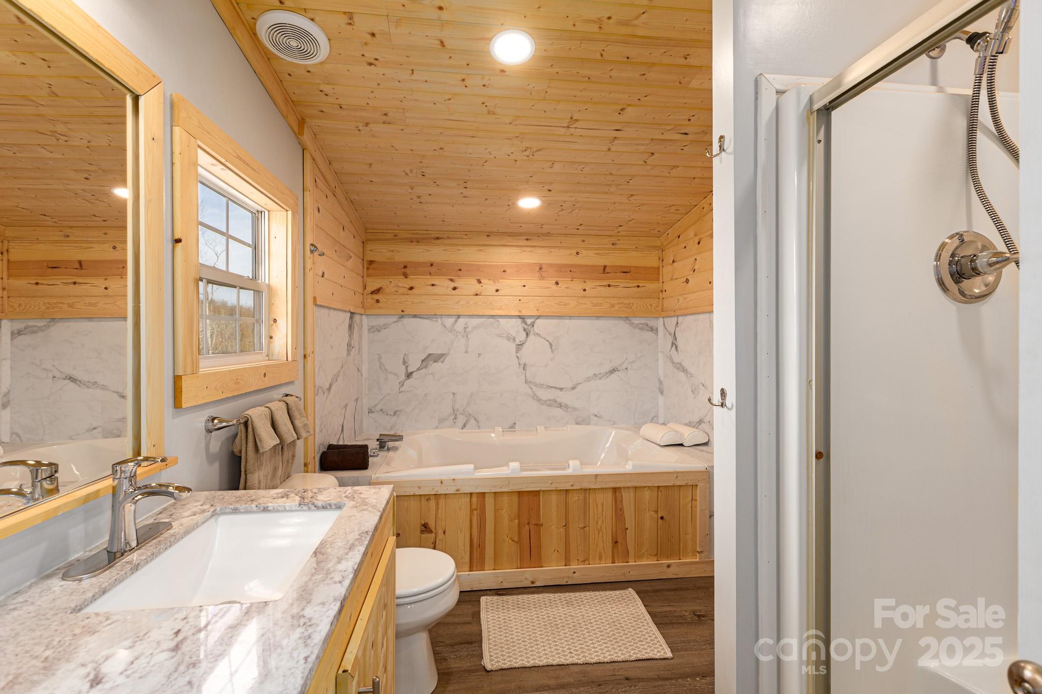 459 Vaughan Road Spruce Pine, NC 28777 - Photo 18 of 35 a bathroom with a tub sink and mirror