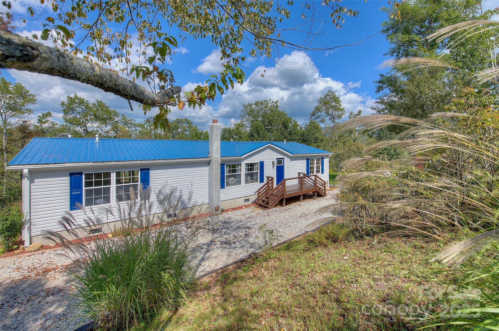 459 Vaughan Road Spruce Pine, NC 28777 - Photo 2 of 35 a front view of a house with a yard