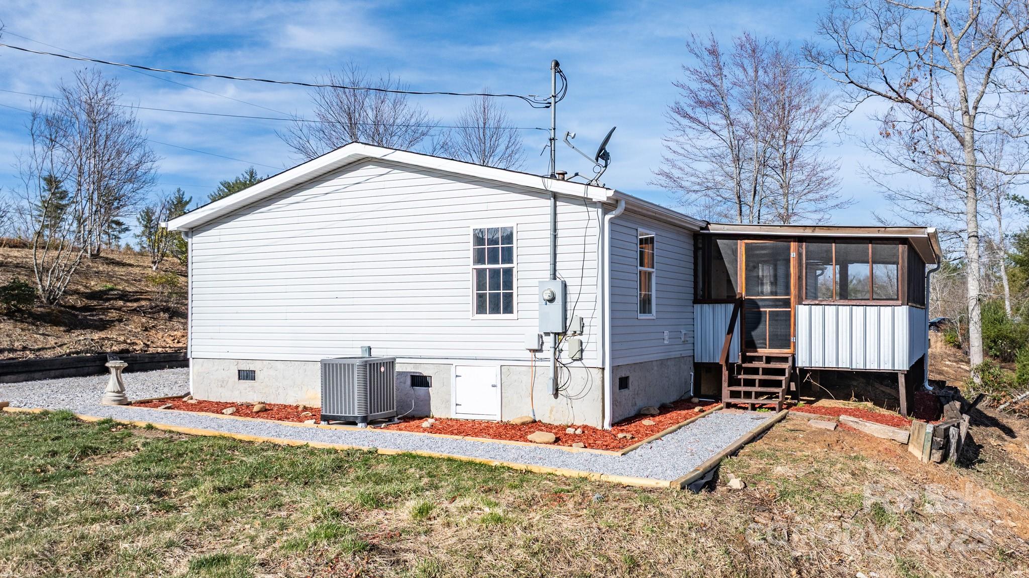 459 Vaughan Road Spruce Pine, NC 28777 - Photo 31 of 35 a view of a backyard with a large tree
