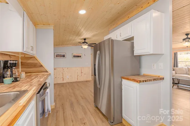 a kitchen with stainless steel appliances granite countertop a refrigerator and a stove