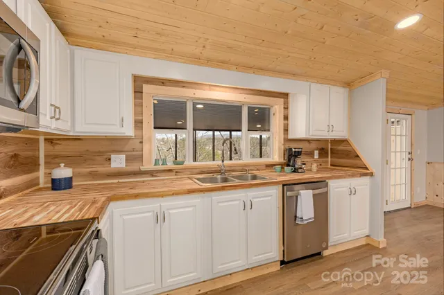a kitchen with stainless steel appliances granite countertop a stove and a sink