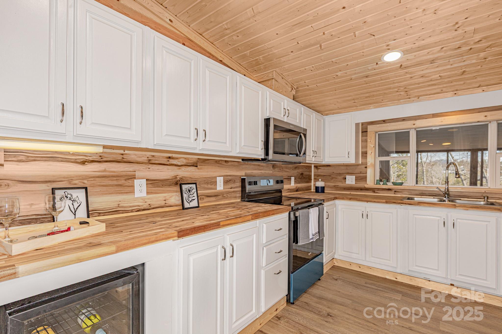 459 Vaughan Road Spruce Pine, NC 28777 - Photo 10 of 35 a kitchen with granite countertop a sink stainless steel appliances and cabinets