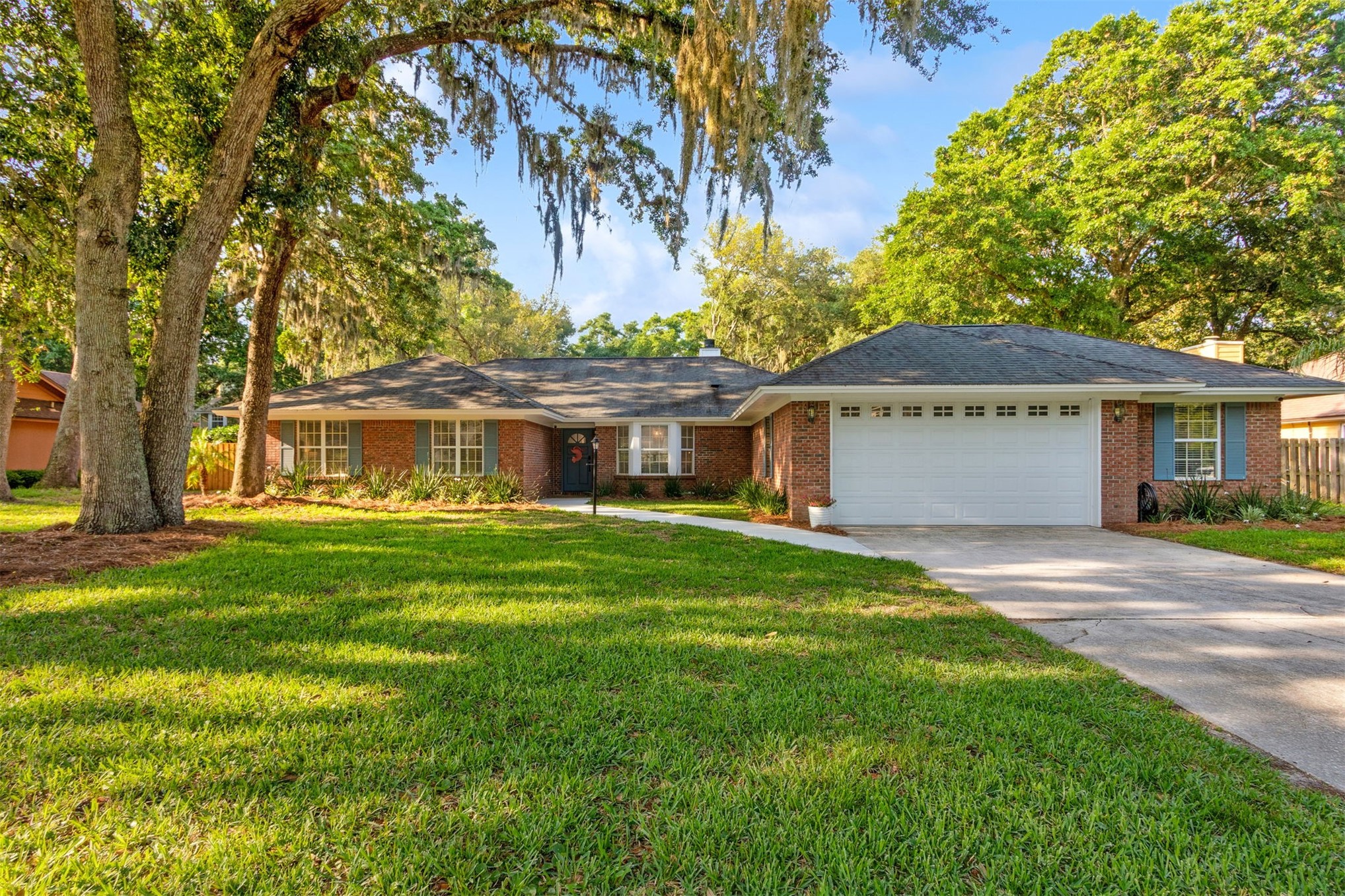 a front view of a house with a garden