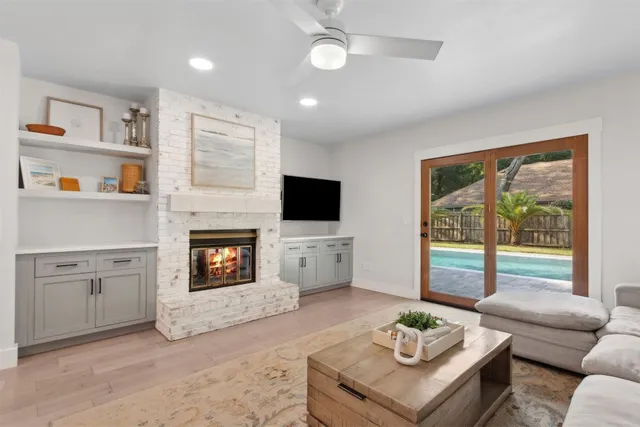 a living room with furniture and view of kitchen