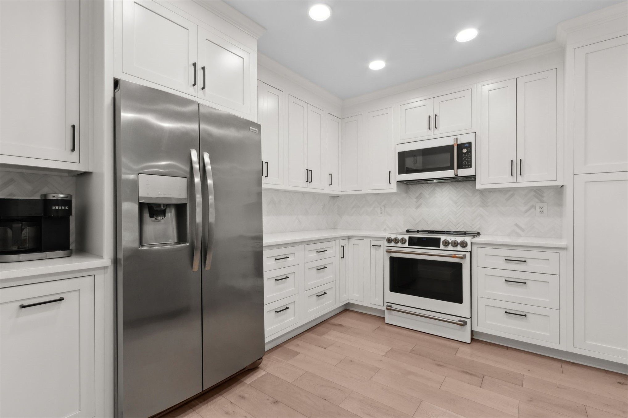 1908 Springbrook Road Fernandina Beach, FL 32034 - Photo 20 of 48 a kitchen with stainless steel appliances and white cabinets