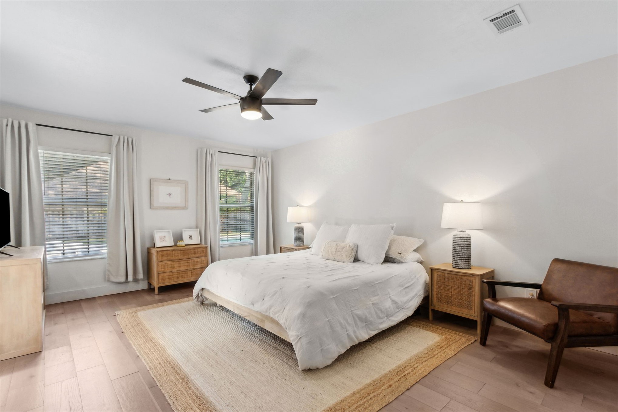 1908 Springbrook Road Fernandina Beach, FL 32034 - Photo 24 of 48 a bedroom with a large bed wooden floor and windows