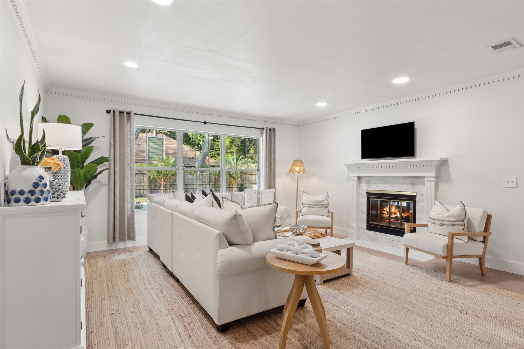 1908 Springbrook Road Fernandina Beach, FL 32034 - Photo 6 of 48 a living room with furniture a fireplace and a flat screen tv