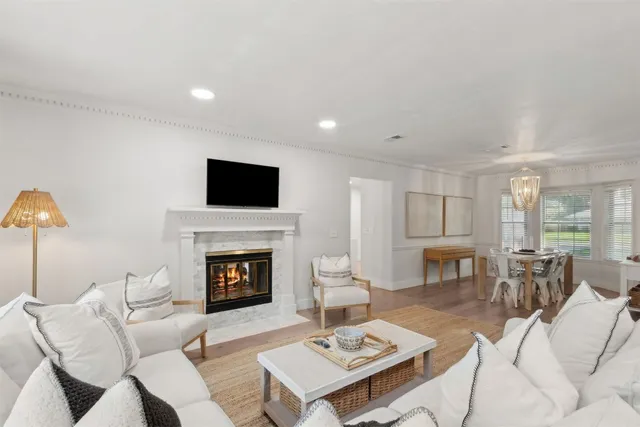 a view of a dining room with furniture a chandelier and wooden floor
