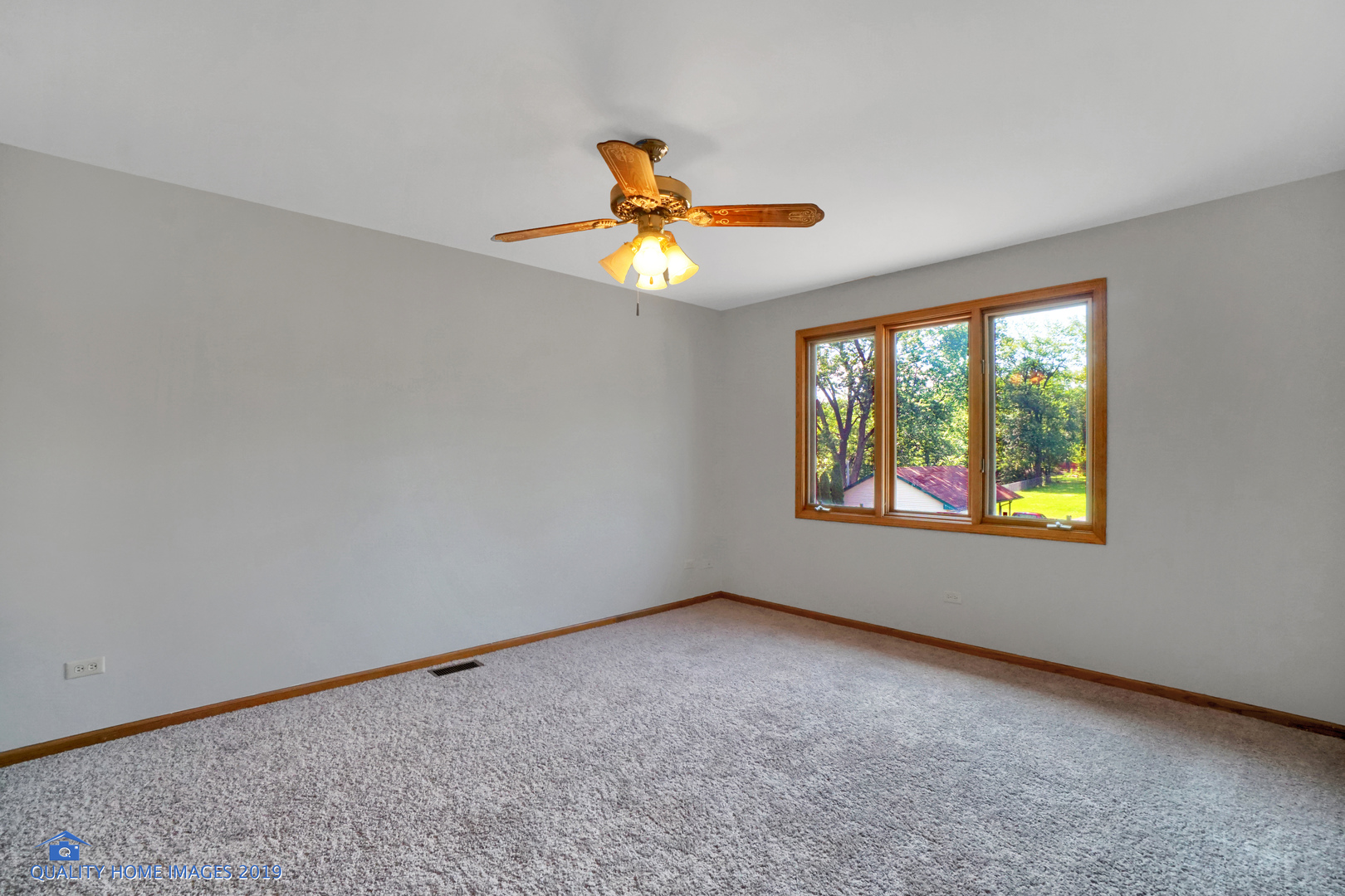 1529 Ridge Road Homewood, IL 60430 - Photo 14 of 28 an empty room with windows and chandelier fan