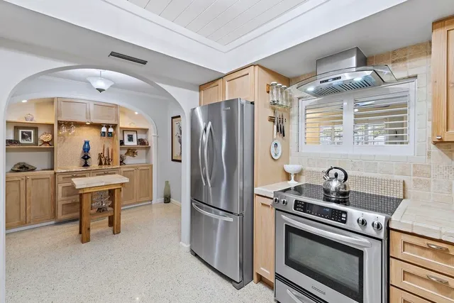 a kitchen with stainless steel appliances a stove a sink and a refrigerator