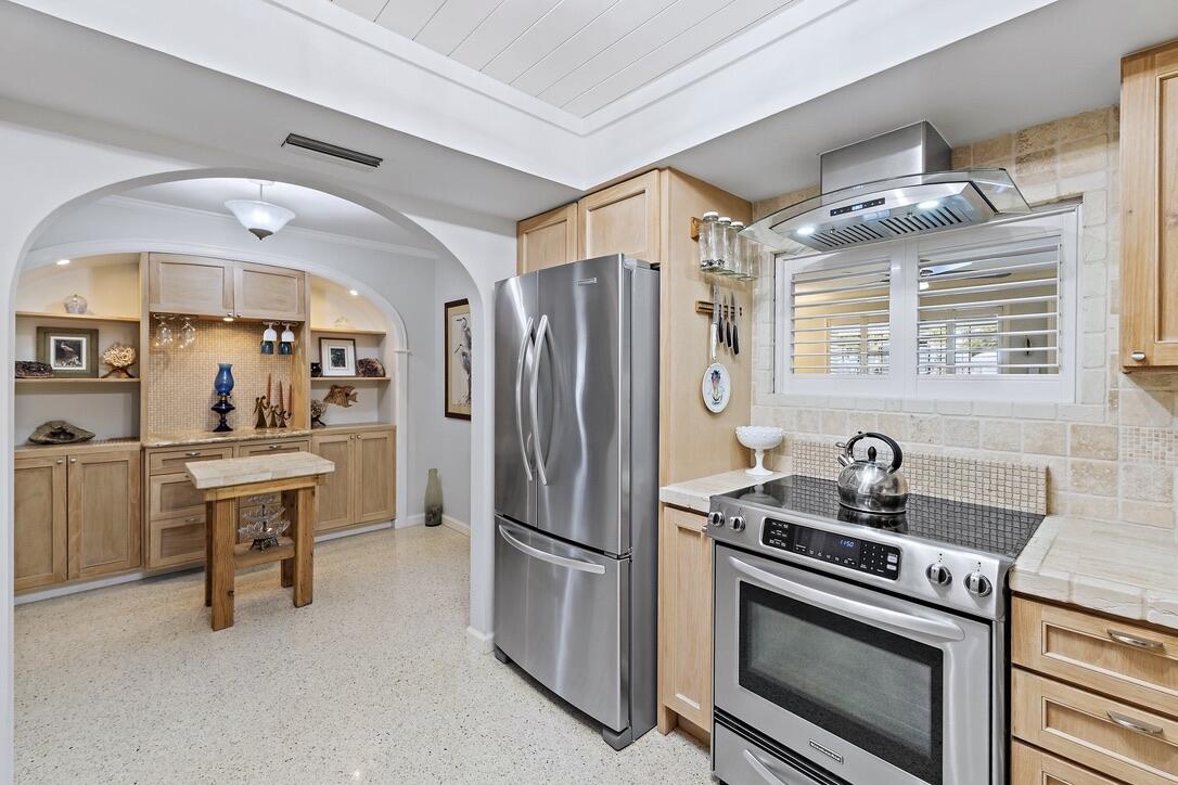 4844 Southeast Pilot Way Stuart, FL 34997 - Photo 11 of 41 a kitchen with stainless steel appliances a stove a sink and a refrigerator