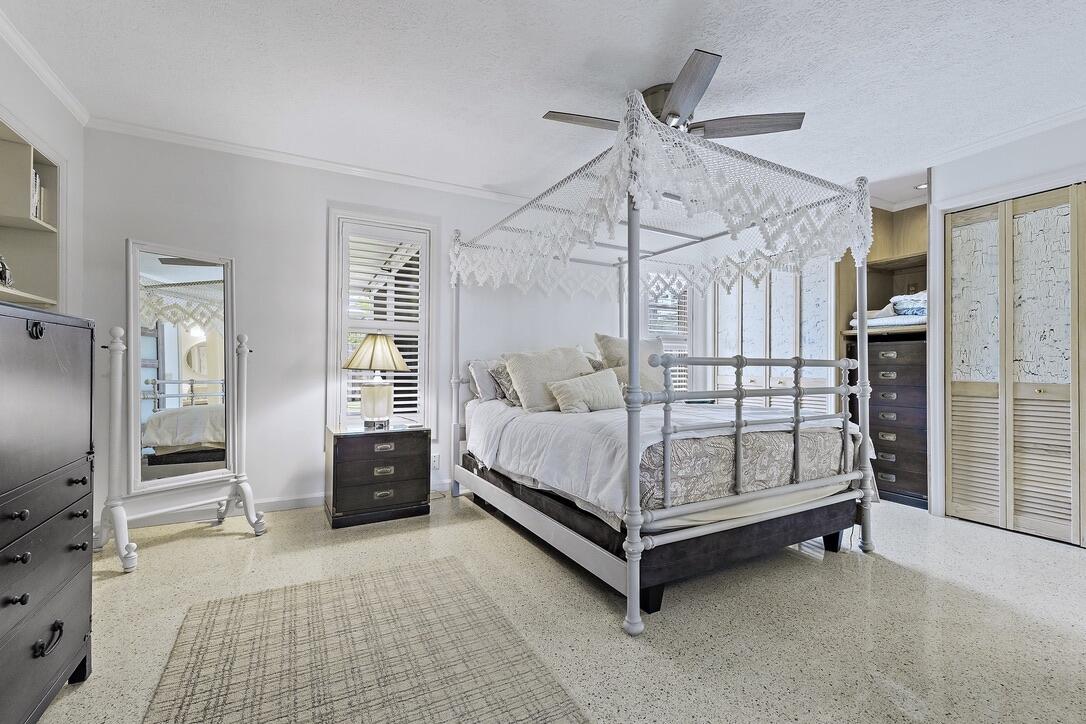 4844 Southeast Pilot Way Stuart, FL 34997 - Photo 17 of 41 a white bed sitting in a room next to a window