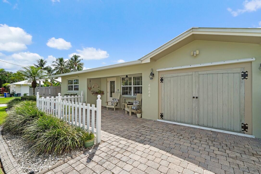 4844 Southeast Pilot Way Stuart, FL 34997 - Photo 2 of 41 a front view of a house with garden