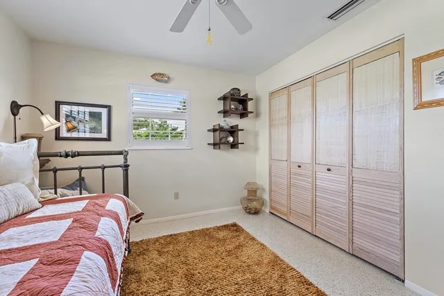 a bed room with a bed and a painting on the wall