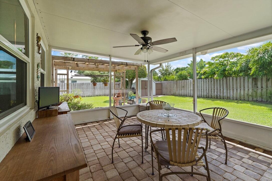 4844 Southeast Pilot Way Stuart, FL 34997 - Photo 25 of 41 a swimming pool with lawn chairs and wooden fence