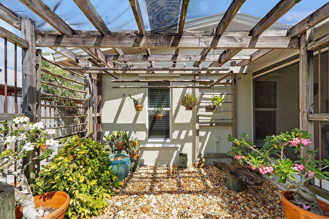 4844 Southeast Pilot Way Stuart, FL 34997 - Photo 30 of 41 a view of a patio with table and chairs and potted plants