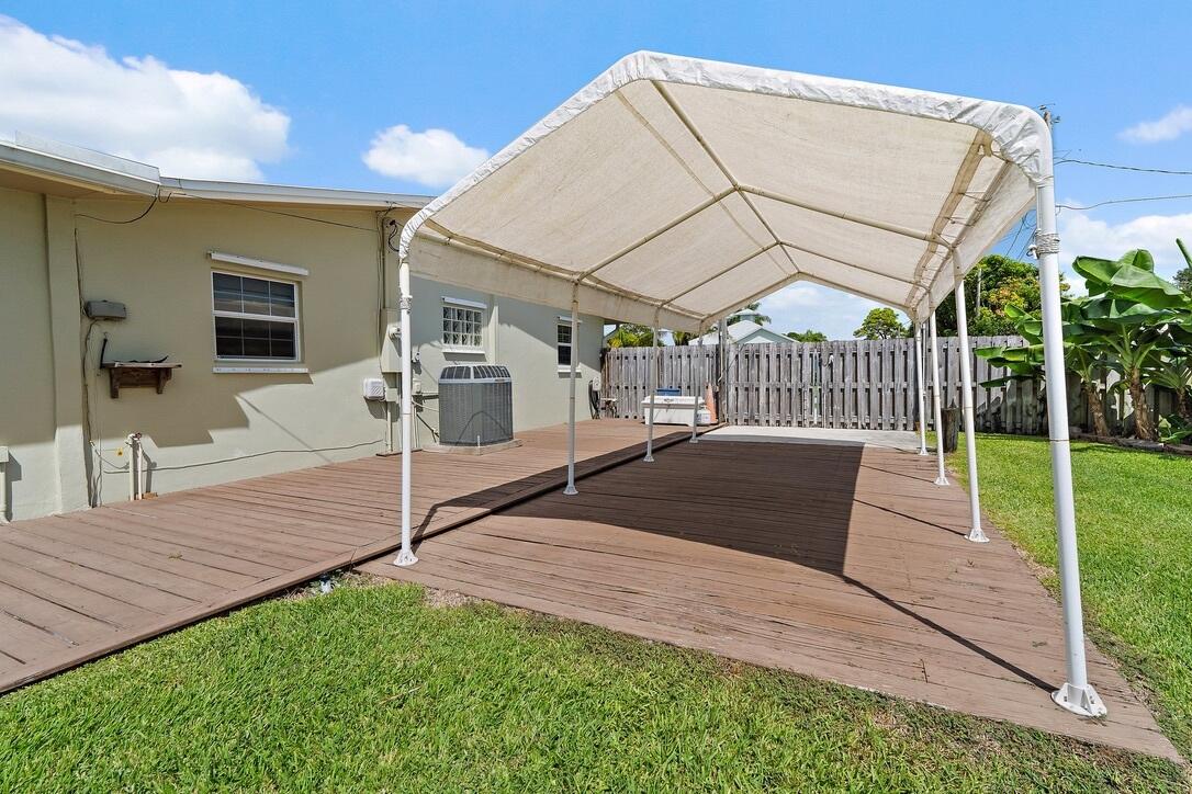 4844 Southeast Pilot Way Stuart, FL 34997 - Photo 32 of 41 a view of house with backyard and porch