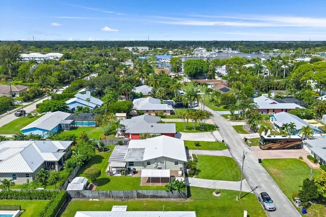 an aerial view of residential houses with outdoor space and street view