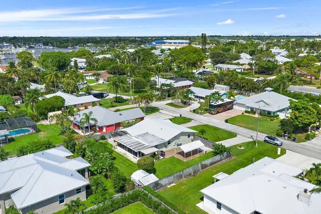 an aerial view of a house with a swimming pool and outdoor space
