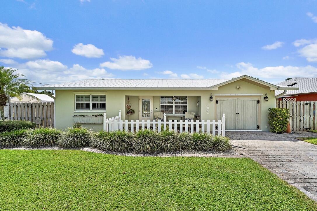 4844 Southeast Pilot Way Stuart, FL 34997 - Photo 40 of 41 a front view of a house with a yard