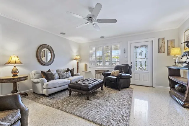 a living room with furniture a rug and a window