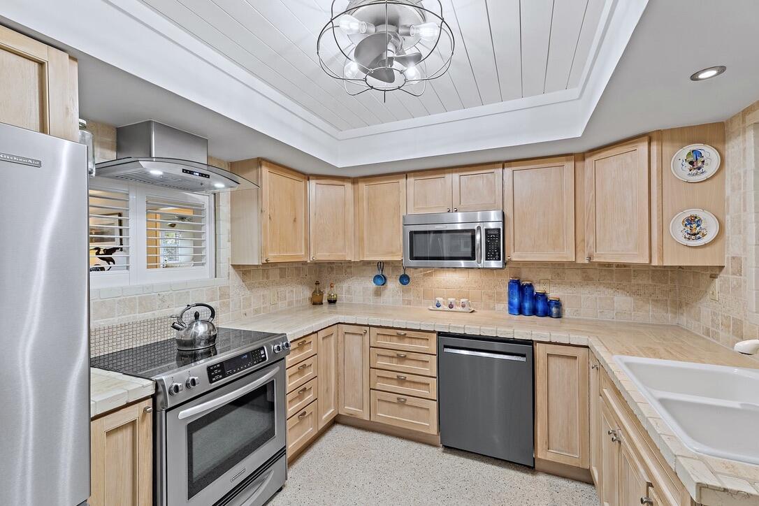 4844 Southeast Pilot Way Stuart, FL 34997 - Photo 8 of 41 a kitchen with a stove sink and cabinets