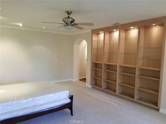 a living room with a furniture and a ceiling fan