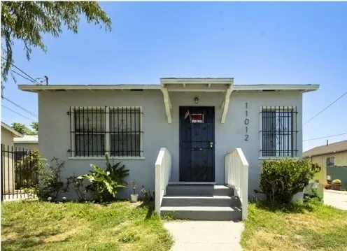 a front view of a house with garden