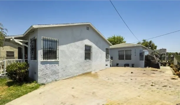 a house that has a tree in front of it