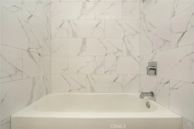 a bathroom with bathtub and shower