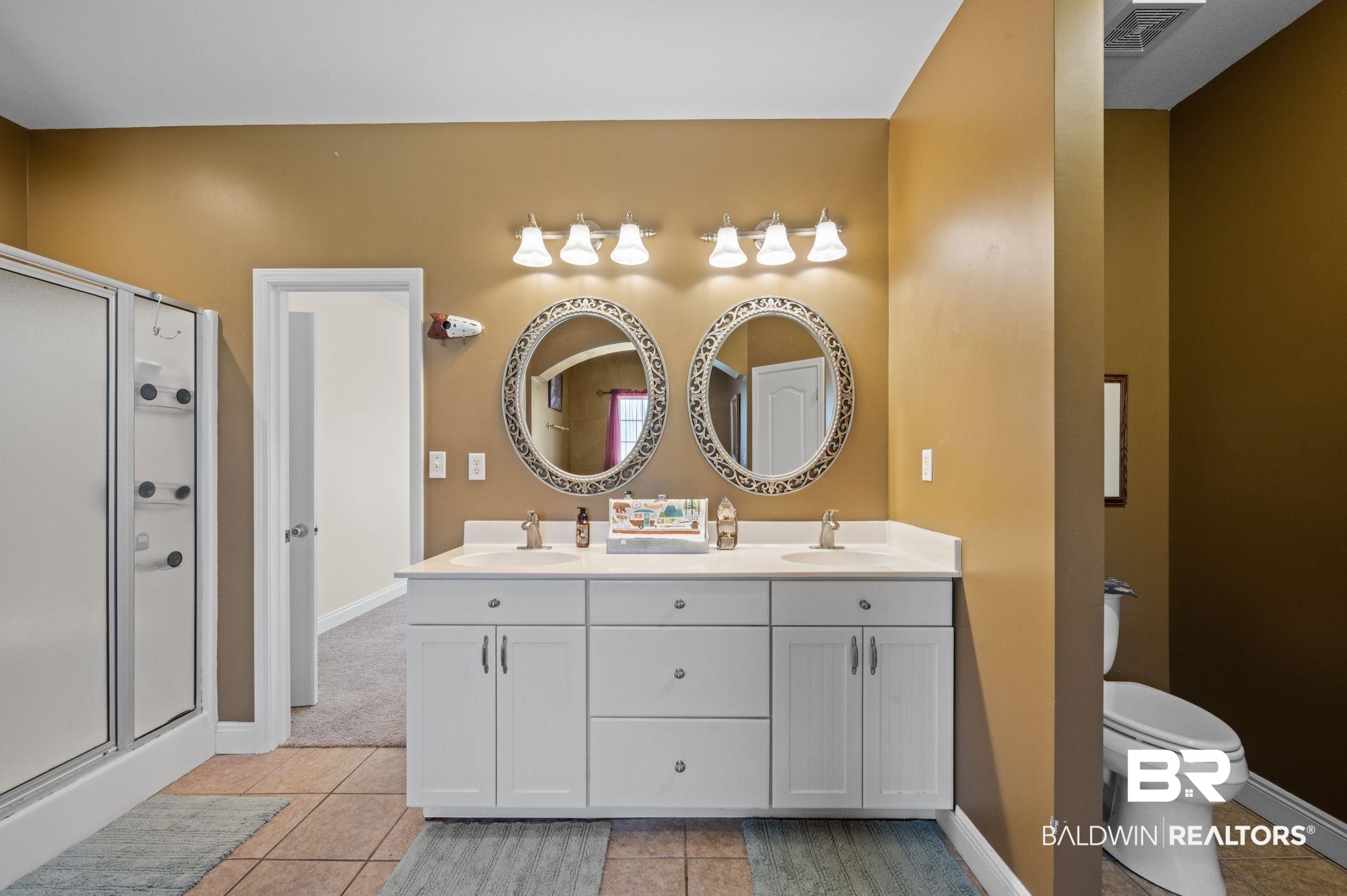 48513 Phillipsville Road Bay Minette, AL 36507 - Photo 23 of 50 Bathroom with a stall shower, tile patterned floors, and double vanity