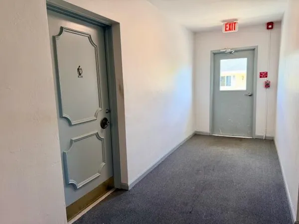 a view of a hallway with front door