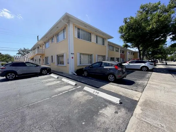 a couple of cars parked in front of a house