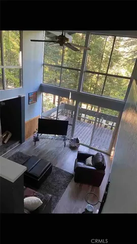 a living room with furniture and a floor to ceiling window