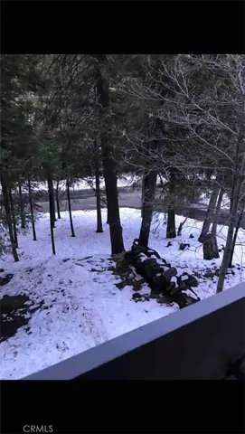 a view of a backyard with table and chairs