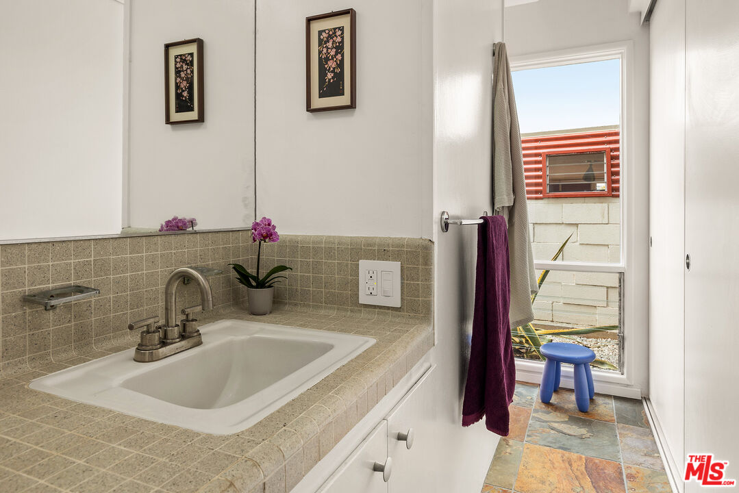 721 Rochedale Way Los Angeles, CA 90049 - Photo 11 of 25 a bathroom with a sink and a mirror