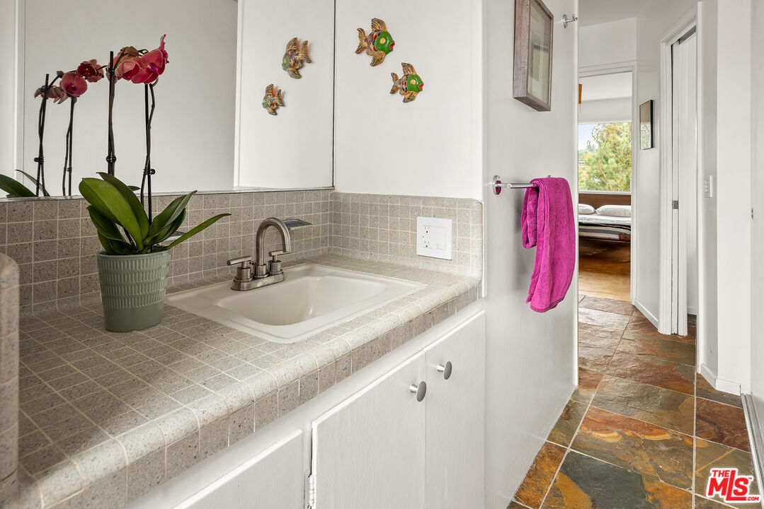 721 Rochedale Way Los Angeles, CA 90049 - Photo 12 of 25 a kitchen with a sink and a potted plant
